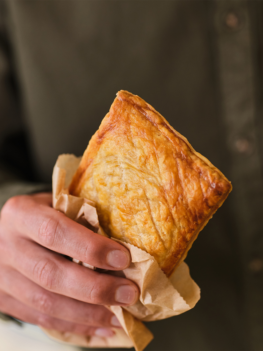 The Cornish Oven Cheese and Onion Slice In Hand